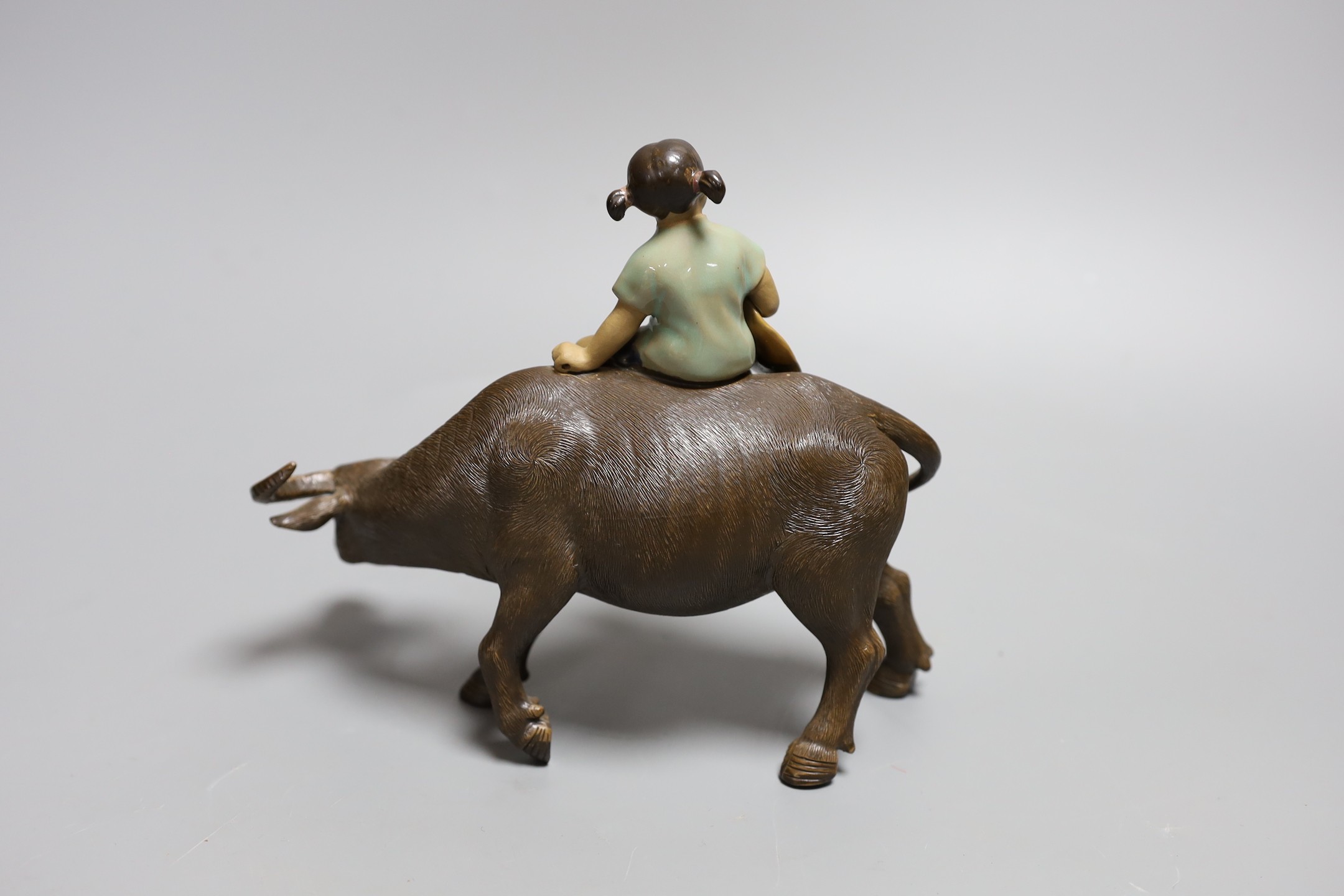 A Chinese Shiwan group of a girl on a buffalo and another, Girl on buffalo 20cms wide